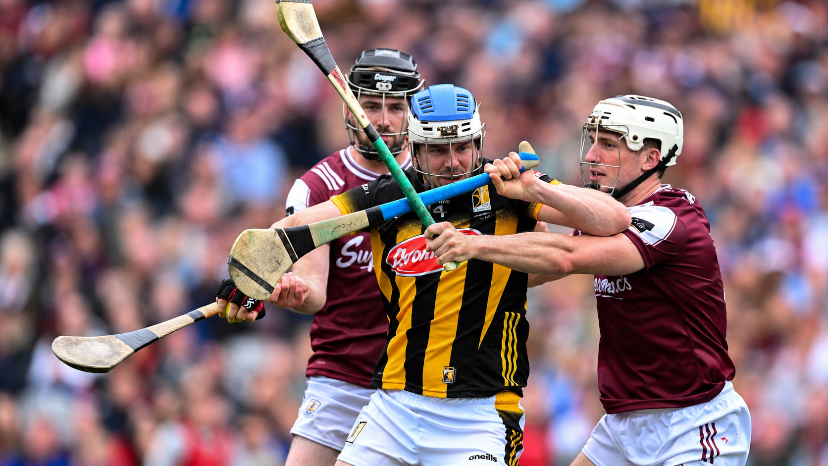 Hurling players contesting possession in a match